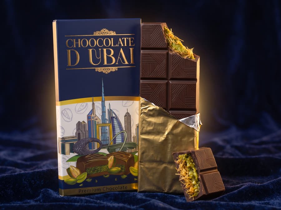 Chocolate Dubai milk chocolate bar carton by Blue Dubai Sweets with a broken bar showing crispy kunafa and pistachio filling